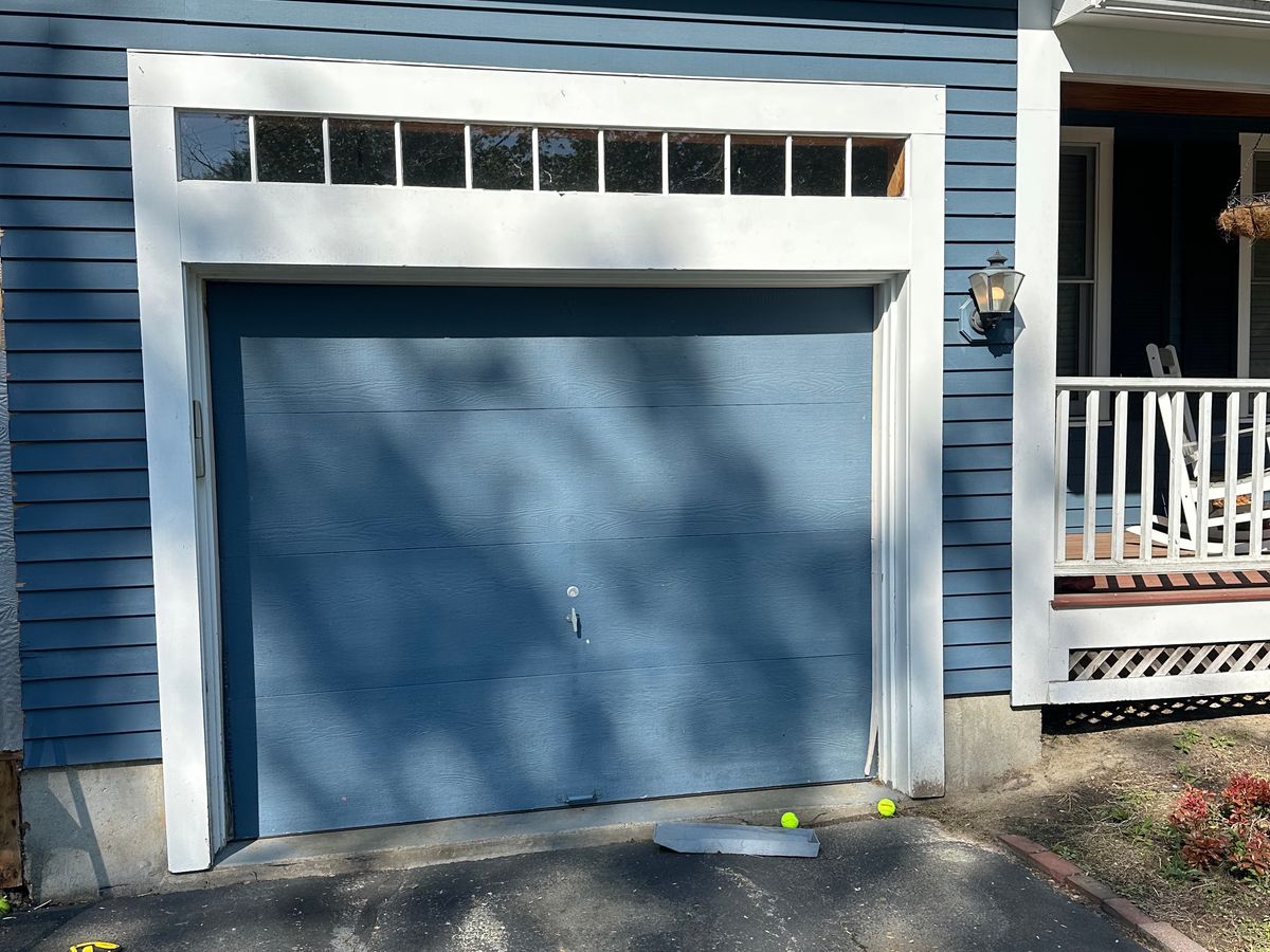 Modern blue garage door with clean lines on contemporary home in Massachusetts