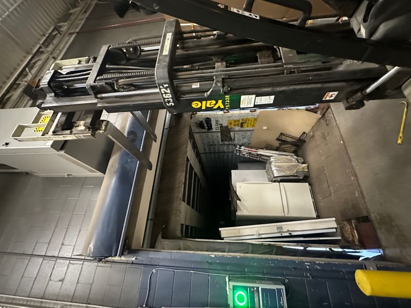 Commercial warehouse interior with Yale forklift and door components ready for install — MA